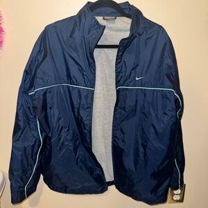 vintage Nike navy blue windbreaker jacket featuring a full-zip closure